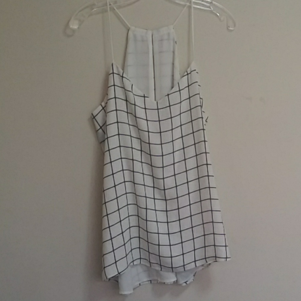 A white and black sleeveless blouse.